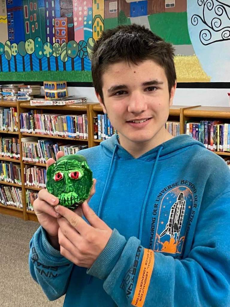 a student holding his rock troll