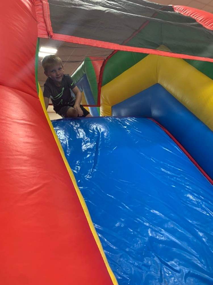the kids going down the inflatable slide.