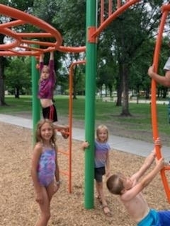 some kids playing on the playground equipment