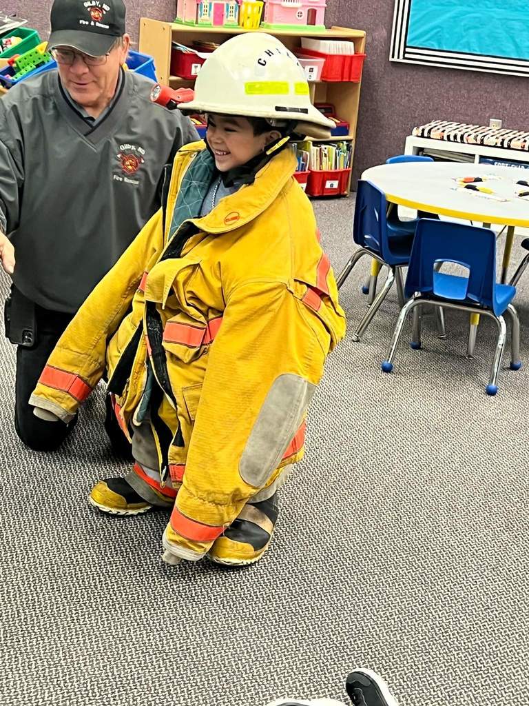 Trying on a fire fighters suit.