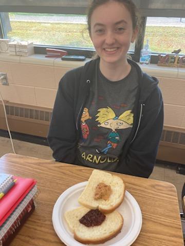 A student with peanut butter and jelly bread.