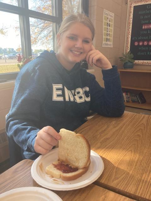 A student sharing her sandwich.