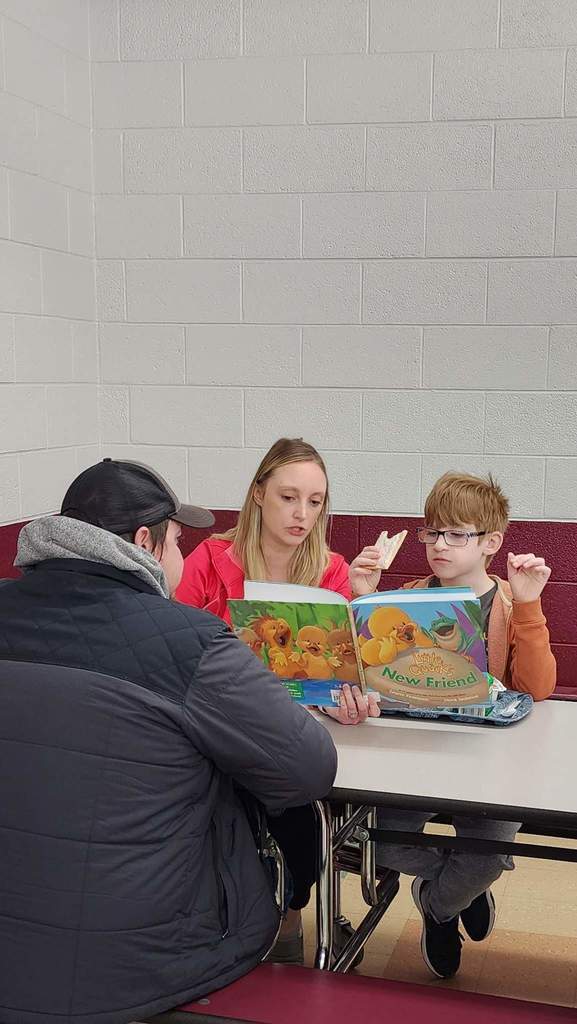 Teacher reading books with their kids.