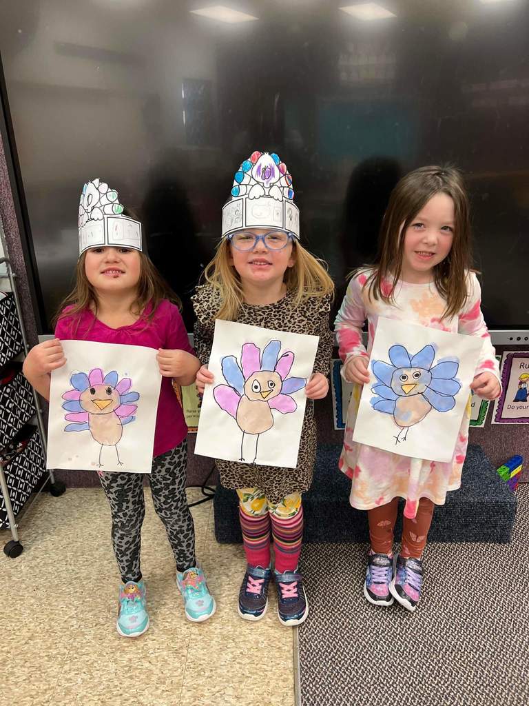 Three girls with their turkey posters.