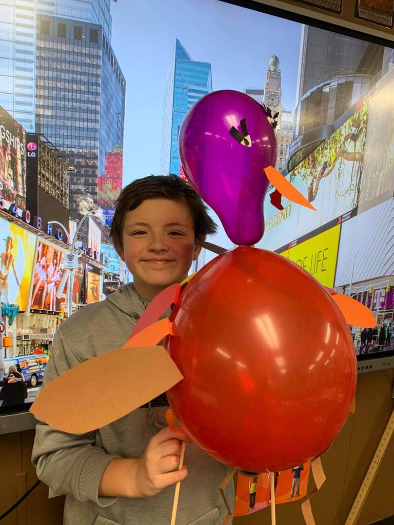 A boy and his turkey balloon creation.