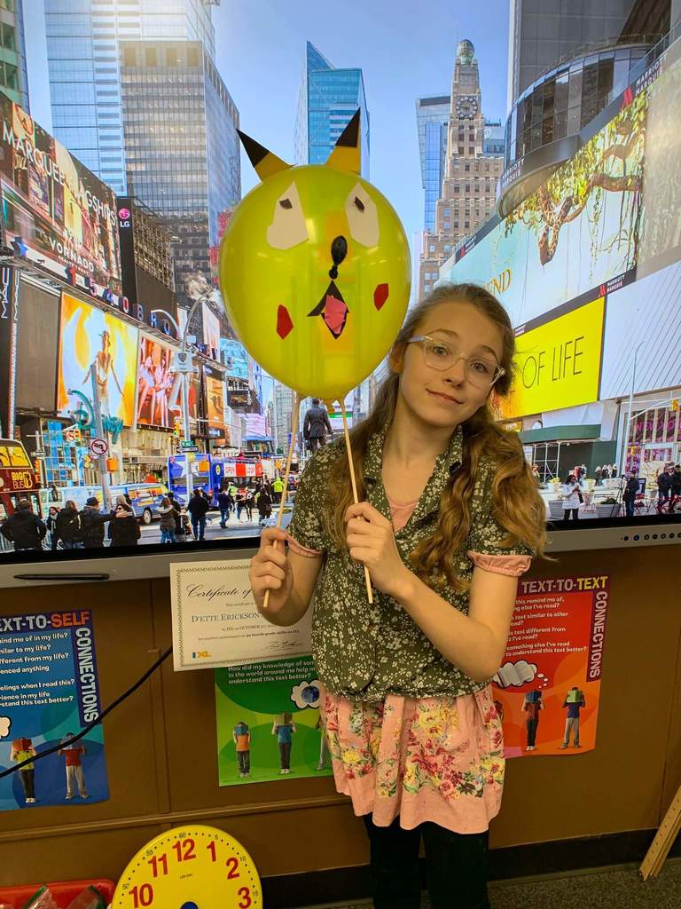 A girl and her Pokémon balloon creation.