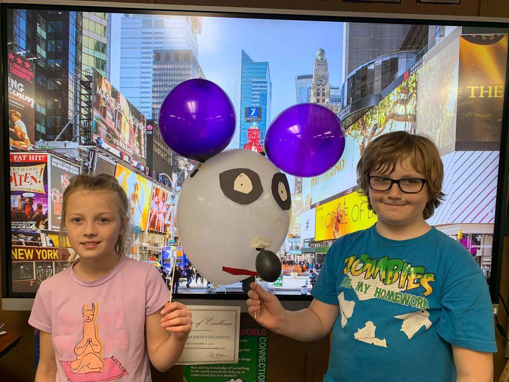 Two students and their balloon character.