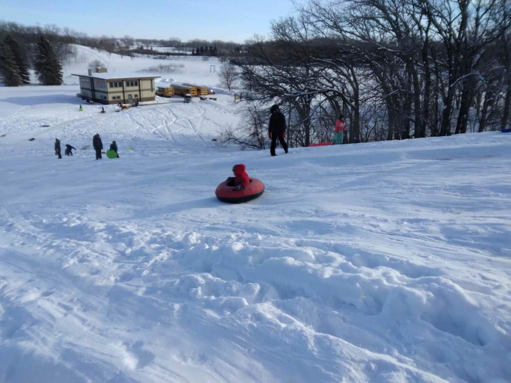 Kids going down the hill.