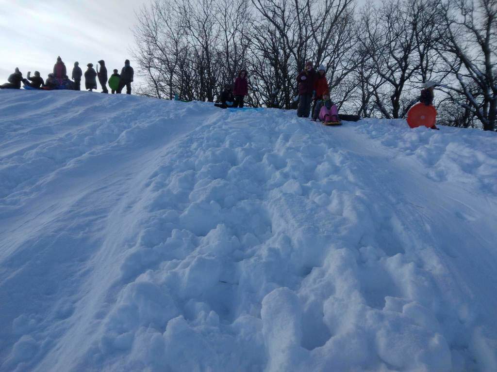 Kids getting ready to go down the hill.