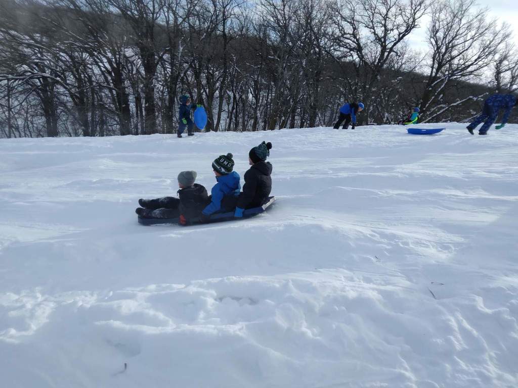 3 kids going down the hill.