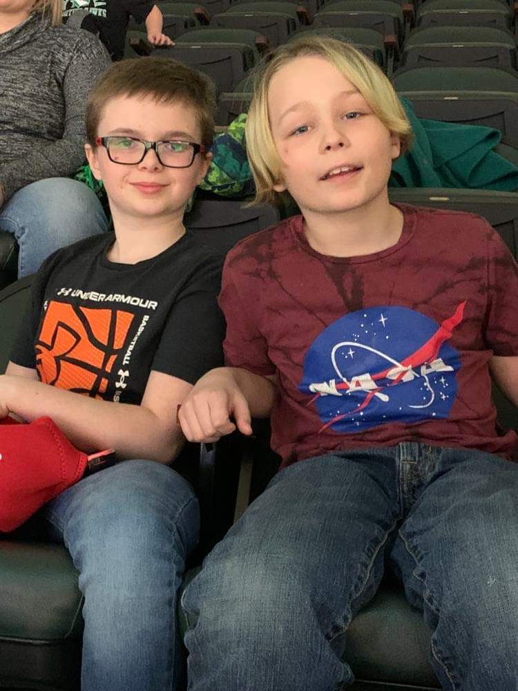 2 boys at a basketball game.