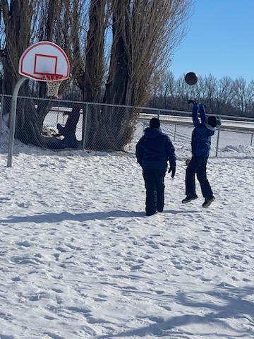 The boys playing basketball.