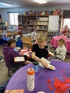 students sampling snacks and books