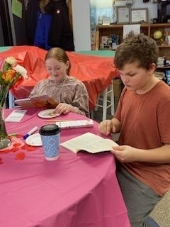 students reading books at the table