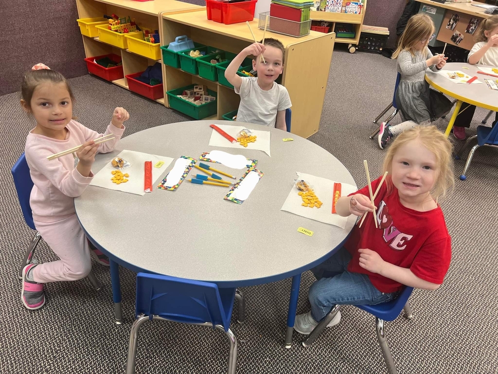 students trying chop sticks