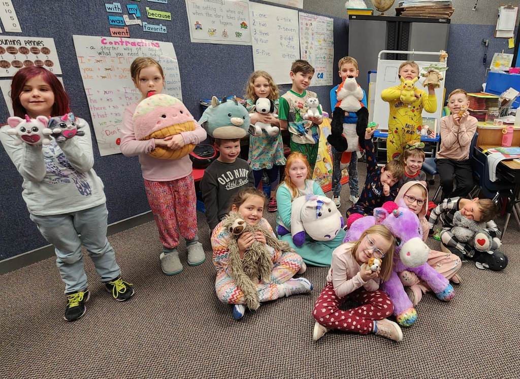 1st grade class in their pjs with stuffed animals