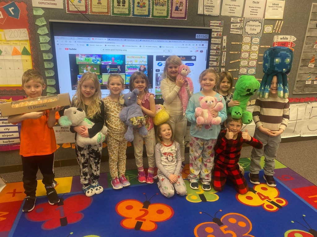 students with donuts, pjs, and stuffed animals.