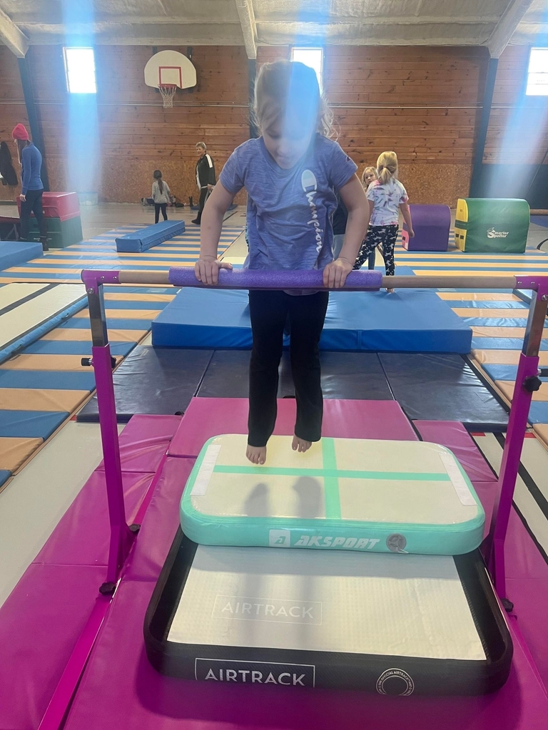 a student jumping on the bar