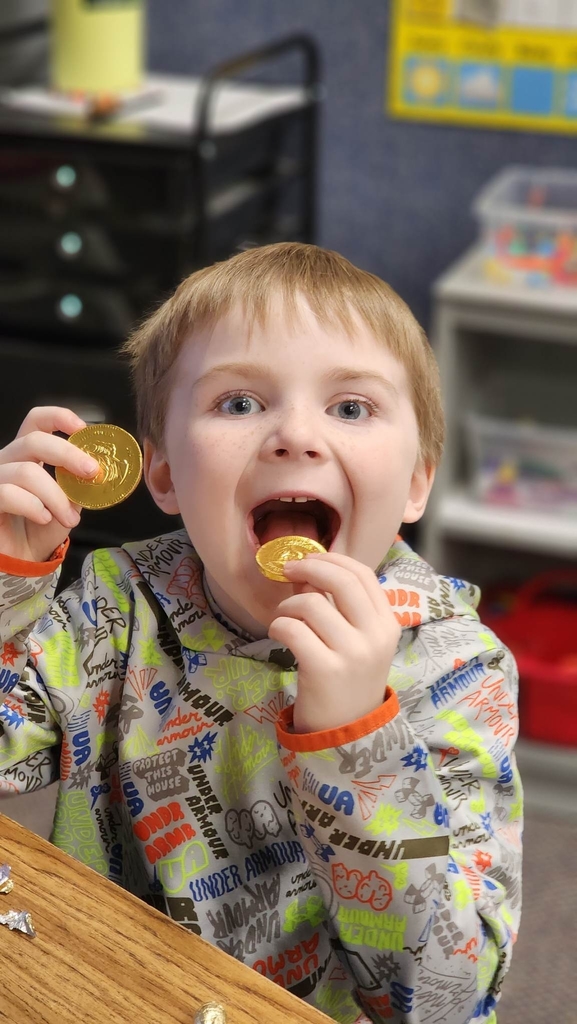 a boy trying to eat his gold coins