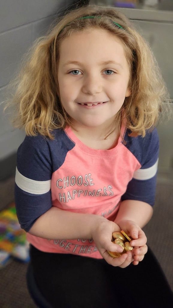a girl smiling with her gold coins