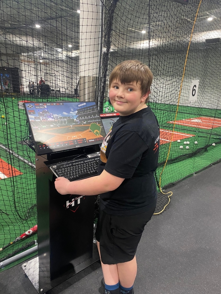 a boy setting up the batting cage