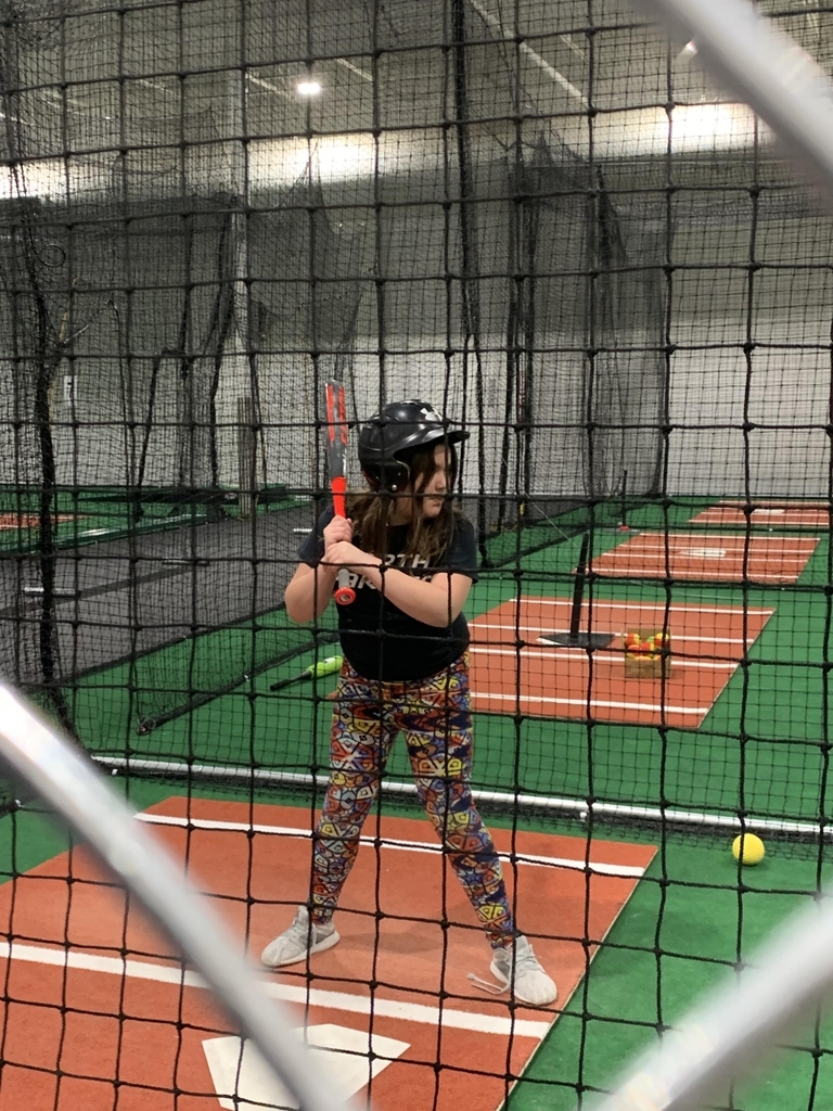 a student in the batting cage