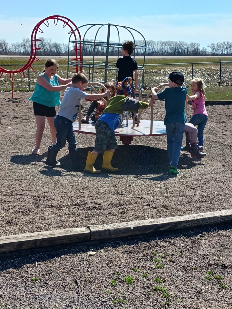 Kids pushing the merry-go-round 
