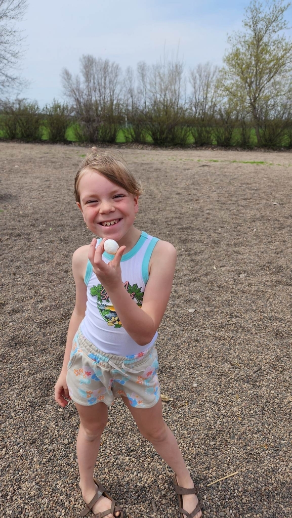 a girl showing her shell she found