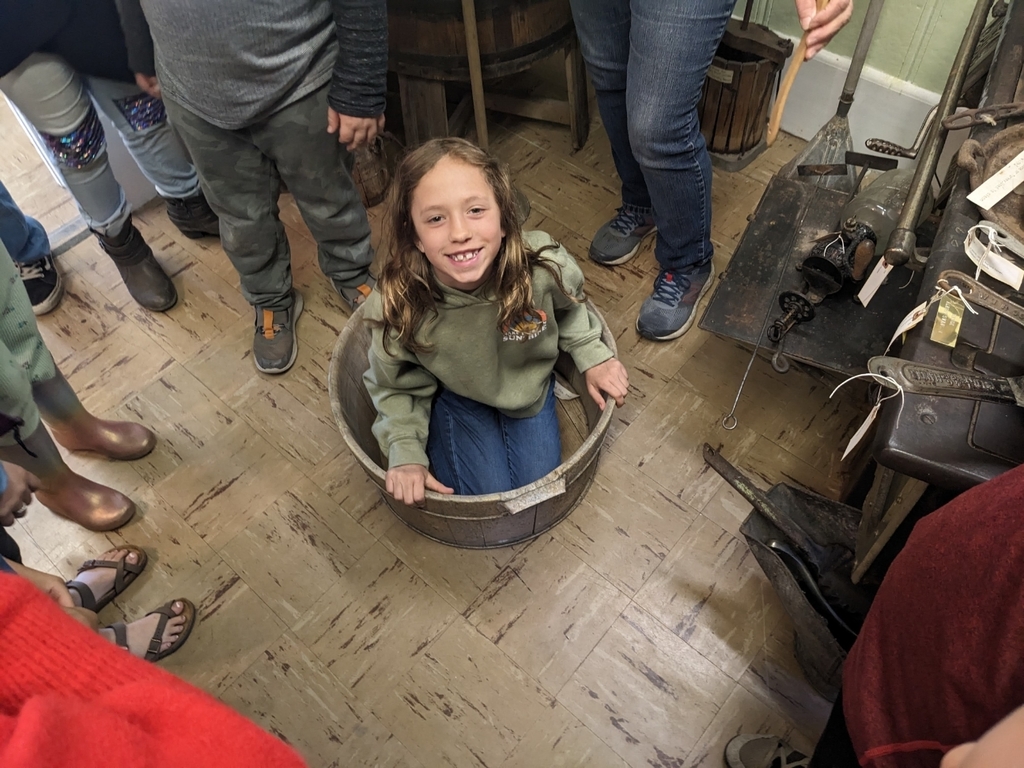 a girl sitting in a bucket