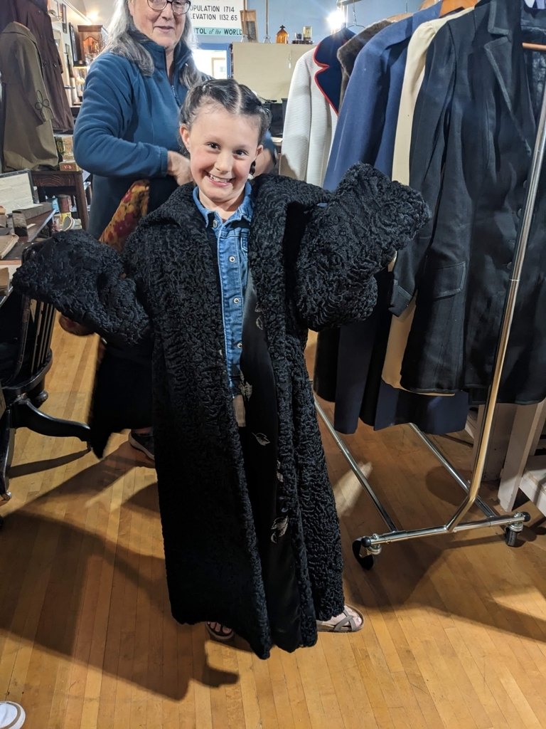 a girl trying on a coat