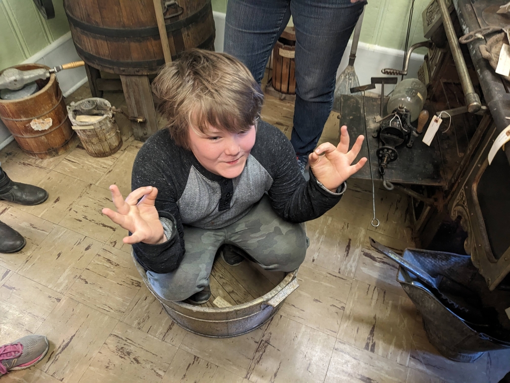 a boy sitting in the bucket