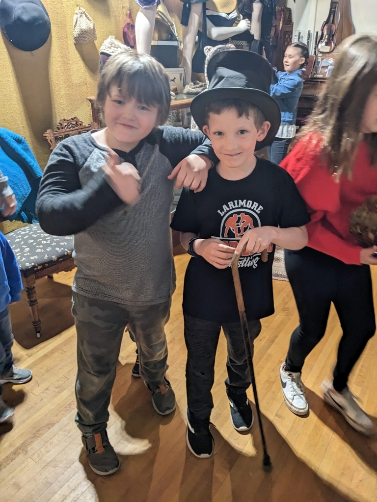 2 boys trying on hats