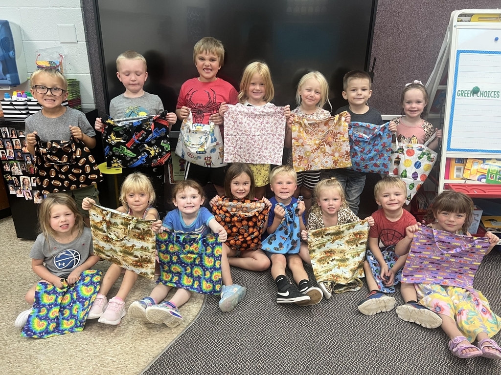the preschoolers with their book bags.